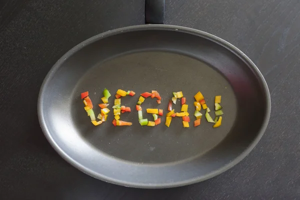Palabra vegana en una sartén — Foto de Stock