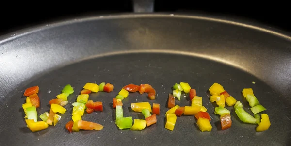 Veganské slovo na pánvi — Stock fotografie