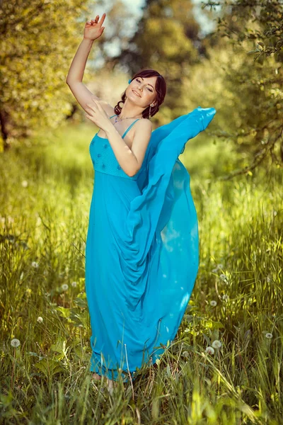 Dziewczyna w piękne błękitne fruwające sukienka. — Zdjęcie stockowe