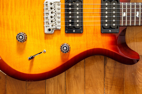 Electric guitar cutwat sunburst colour on wooden floor