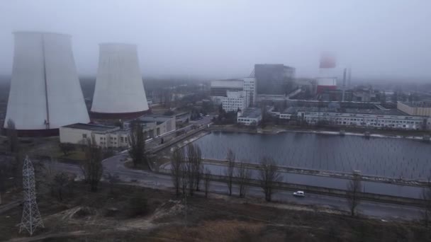 Aerial view from a drone to a thermal power plant in cloudy foggy weather — стоковое видео