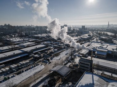 Aerial view from a drone to the factory and to air pollution in the city