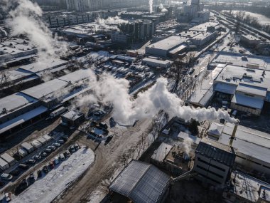 Aerial view from a drone to the factory and to air pollution in the city
