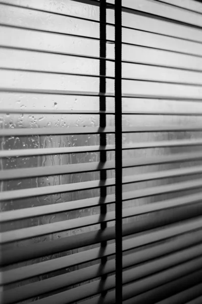 Metal blinds on windows in rainy weather — Stock Photo, Image