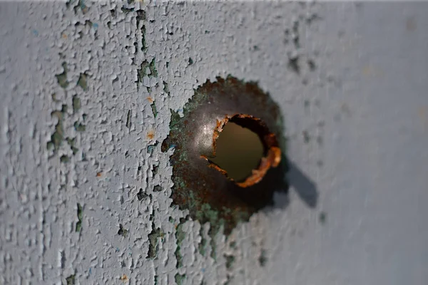 Fence near the house with bullet hole and charapnels after gunshots and fighting during the invasion of Russian troops into Ukraine