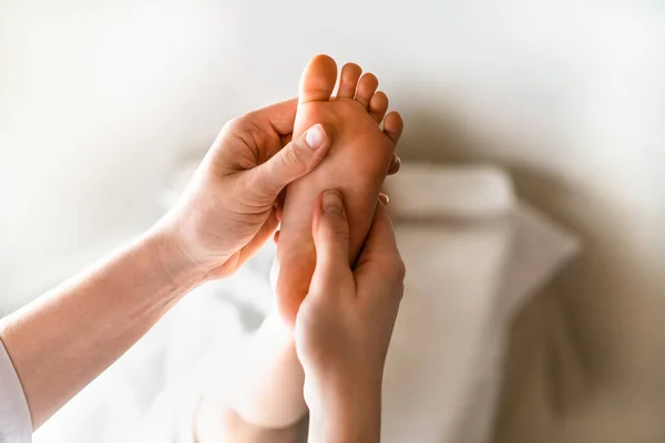 a woman gives a massage to a little girl, childrens massage, prevention of scoliosis, osteopathy, copy space