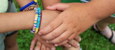 The children put their hands together. Selective focus. kids