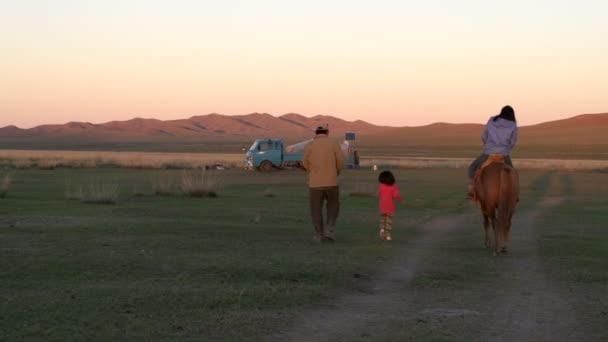 Батько і дочка йдуть поруч з конем з дочкою — стокове відео