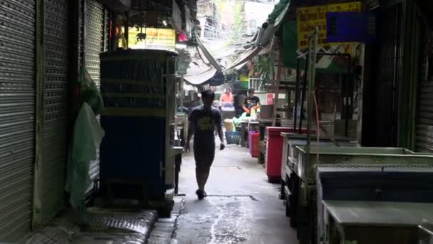 Muž šel směrem k fotoaparátu v malé uličce v čínské čtvrti — Stock video