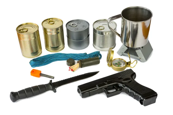 Survival kit with emergency supplies and gun — Stock Photo, Image