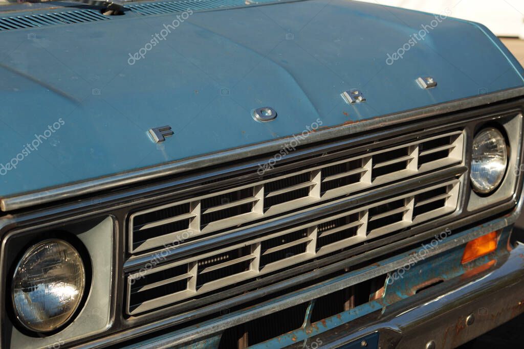 New York, NY - October 2, 2021: Front hood and grill of 1975 Ford E150 Econoline Chateau Club Wagon with name logo.