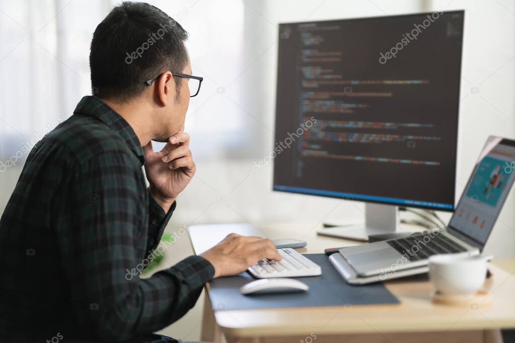 software develper working on laptop at home office. Programmer working develop web application. Software programming concept