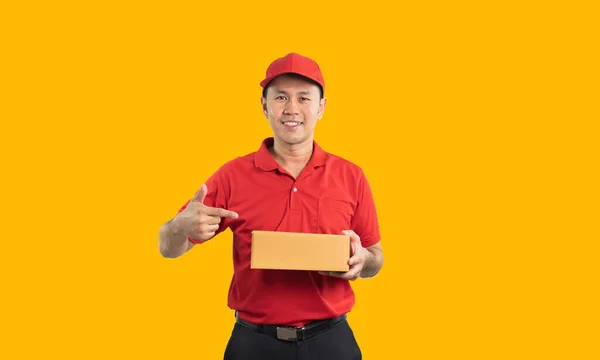 Asian Delivery Man Worker Smiling Pointing Finger Box Red Uniform — стоковое фото