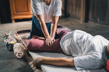 Massage and spa relaxing treatment of office syndrome traditional thai massage style. Asain senior female masseuse doing massage treat hand, back pain, arm pain, foot and stress for old woman tired.