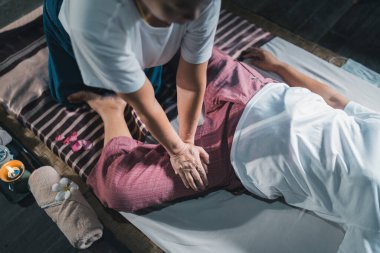 Massage and spa relaxing treatment of office syndrome traditional thai massage style. Asain senior female masseuse doing massage treat hand, back pain, arm pain, foot and stress for old woman tired.