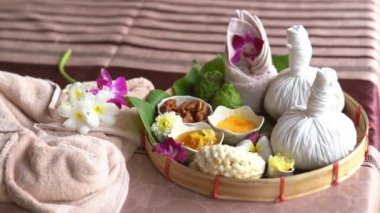 Spa massage wellness decorations setting on wood table. Thai spa massage traditional compress for hot massage and spa relaxing treatment of office syndrome. Massage for health concept.