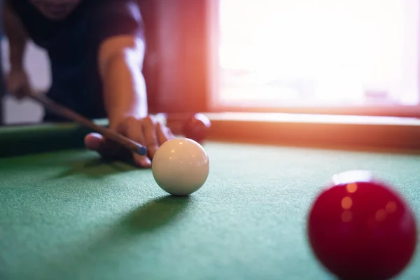 Close up on white and red snooker ball or pool on the snooker table. Snooker player competition snooker game, bet. Indoor snooker sport.