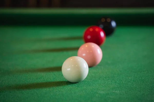 Close up on white and red snooker ball or pool on the snooker table. Snooker player competition snooker game, bet. Indoor snooker sport.