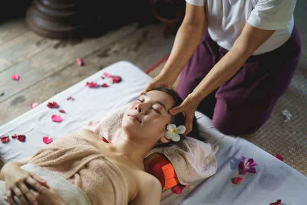 Massage and spa relaxing treatment of office syndrome traditional thai massage style. Asain female masseuse doing massage treat back pain, arm pain and stress for office woman tired from work.