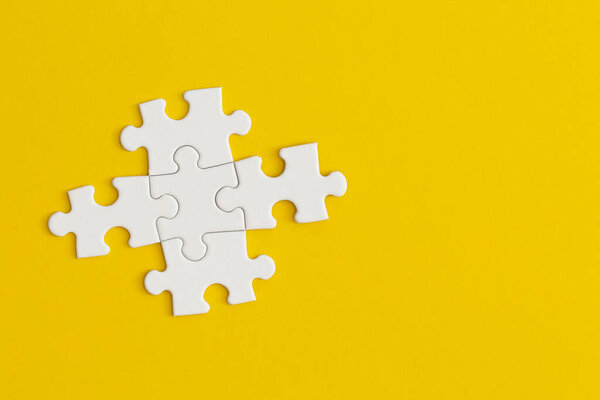 White details of puzzle on yellow background.