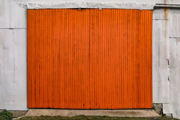 a painted orange garage barn door hanging doors steel warehouse building farming shed shelter industrial entrance