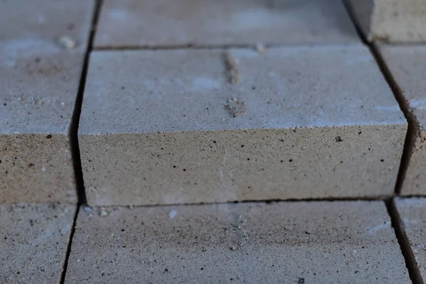 Lots of new white sand-lime air bricks in a stack close-up. Production of building materials.