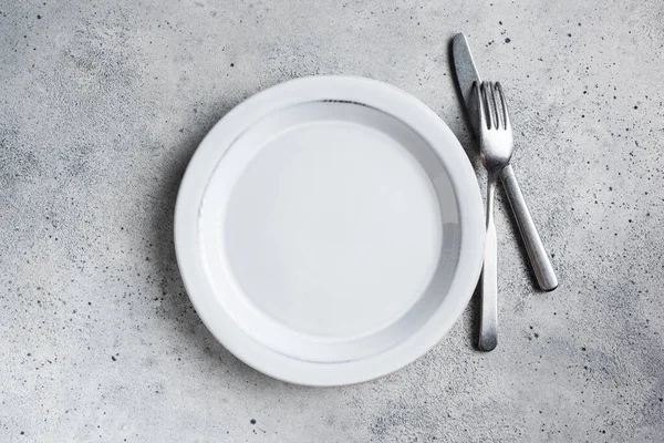 Empty plate and silver cutlery Stock Image