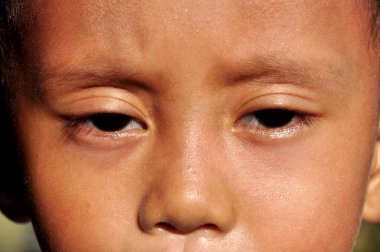 Önüne bakan Endonezyalı bir çocuğun yakın çekimi.