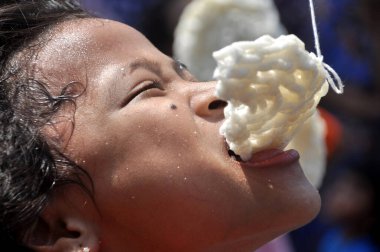 Jakarta, Indonesia - August 17, 2014 : Children taking part in a cracker eating competition at the celebration of Indonesia's independence day in Jakarta