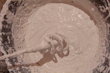 Kokuyor. Macun hazırlığı. Tamirat sırasında duvar macunu için harç karıştırılıyor.