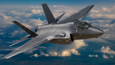 Lockheed Martin F-35 Lightning II  in flight above the clouds clipart