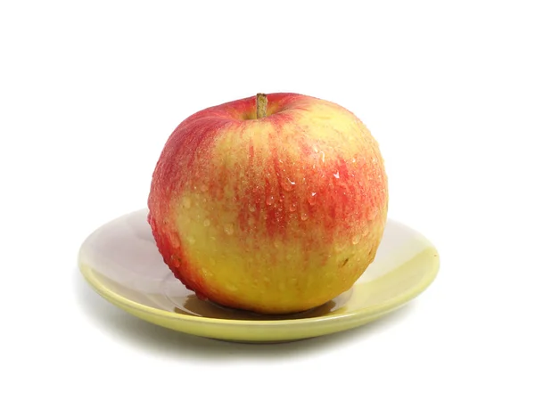 Apple red on a green plate — Stock Photo, Image