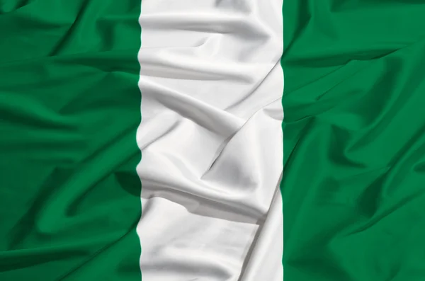 Nigeria flag on a silk drape — Stock Photo, Image