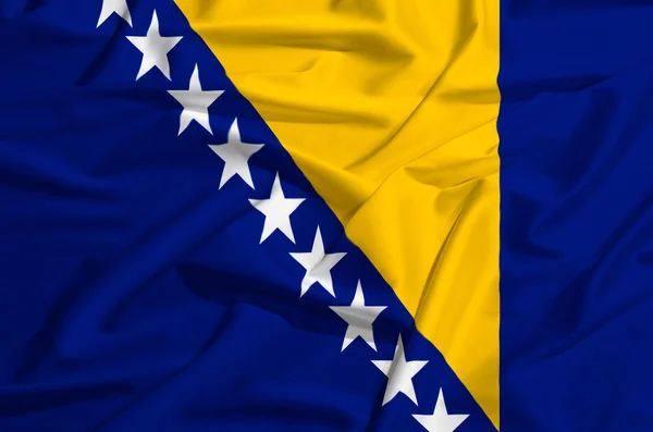 Drapeau de Bosnie sur un rideau de soie agitant — Photo