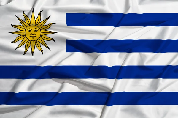 Drapeau de l'Uruguay sur un rideau de soie agitant — Photo
