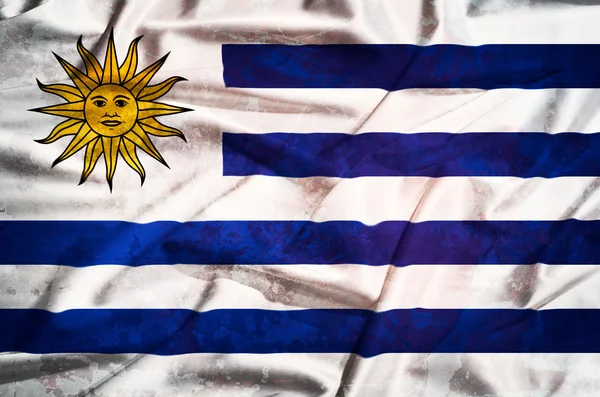 Bandera grunge de Uruguay sobre una cortina de seda ondeando — Foto de Stock