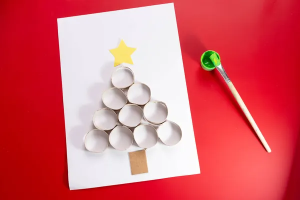 手作りのクリスマスツリーは、トイレットペーパーのロールで構成され、クリスマスカードのコンセプトを描く — ストック写真