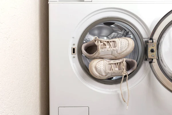 dirty sneakers in the washing machine. cleaning sporty shoes at home