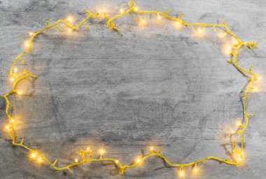 christmas lights frame with copy space on wooden background .