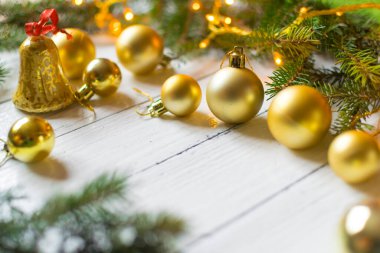 Beautiful christmas decoration (baubles, lights, pine branches) on old white, wooden background. Place for text included