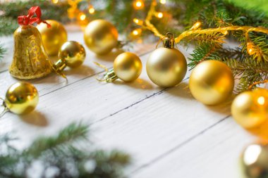 Beautiful christmas decoration (baubles, lights, pine branches) on old white, wooden background. Place for text included