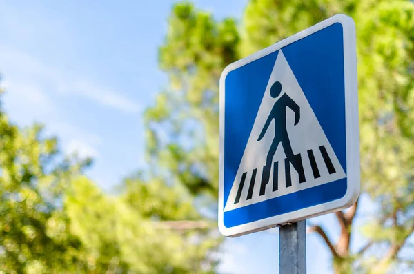 Urban road sign indicating a pedestrian crossing