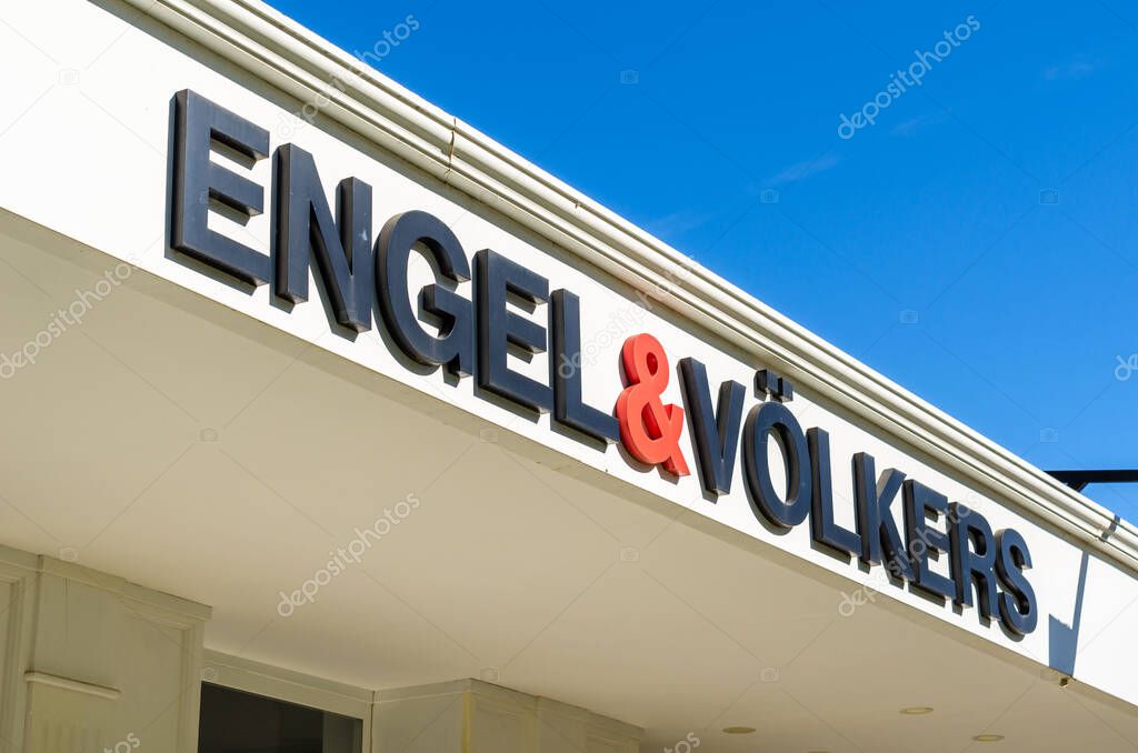 MADRID, SPAIN - SEPTEMBER 26, 2021: Engel & Volkers real estate logo in an office in Madrid, Spain. Engel & Volkers is a German company that via a series of franchised offices, provides services related to real estate transactions