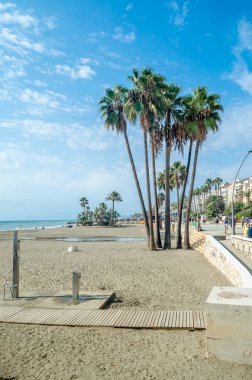 ESTEPONA, İspanya - 12 Ekim 2021: Güney İspanya 'nın Malaga eyaleti Costa del Sol' da bir kasaba olan Estepona 'nın kıyı şeridinde gezinen insanlar