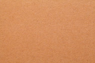 Flat Brown Cardboard Smooth Textured Background Close Up.