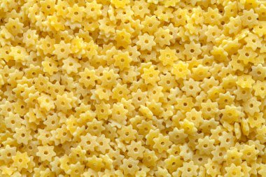 Large Pile of Dry Star Pasta Background Texture.