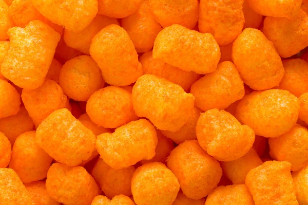 Orange Cheese Puff Balls Haufen Hintergrund Nahaufnahme — Stockfoto