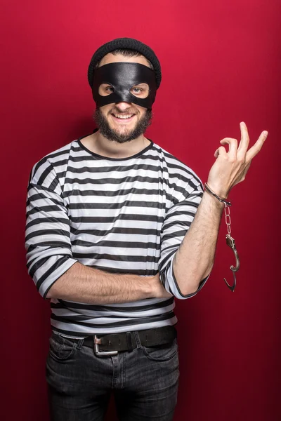 Thief with handcuffs smiling — Stock Photo, Image