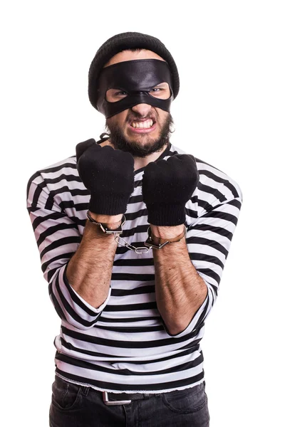 Angry burglar with handcuffs — Stock Photo, Image