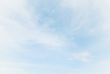 Background of bright sky and background of thin clouds, sky clouds, blue sky and white clouds float in the sky on a clear day with warm sunlight.